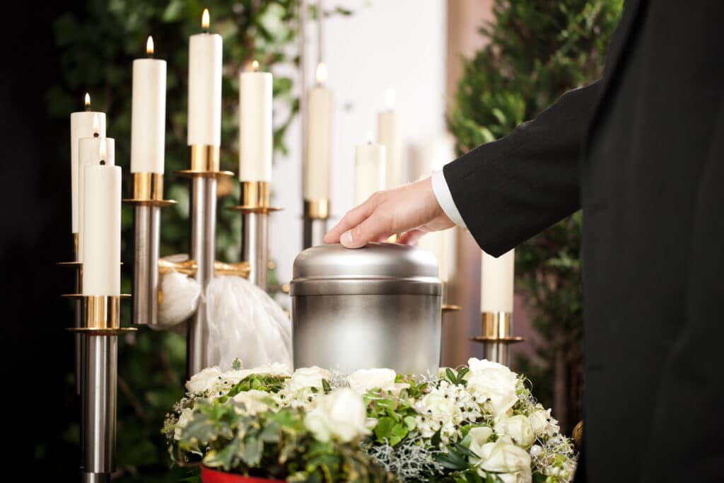 funeral urn with candles flowers